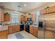 Kitchen with wood cabinets, stainless steel appliances at 2367 W Jake Hvn, Phoenix, AZ 85085