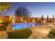 Inviting swimming pool with a spacious deck and landscape lighting at 26735 W Quail Ave, Buckeye, AZ 85396