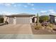 Single-story home with two-car garage and desert landscaping at 26788 W Yukon Dr, Buckeye, AZ 85396