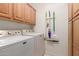 Laundry room with washer, dryer, and overhead cabinets at 2714 N 63Rd St, Mesa, AZ 85215