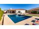 Inviting rectangular pool with a spacious backyard and lounge chairs at 2714 N 63Rd St, Mesa, AZ 85215