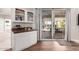 Built-in wet bar with granite countertop and glass-front cabinets at 2714 N 63Rd St, Mesa, AZ 85215