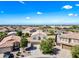 High-angle shot showcases the arrangement of single-Gathering homes with attached garages, tiled roofs, and well-kept lawns in the neighborhood at 2776 E Mews Rd, Gilbert, AZ 85298
