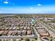 Aerial view showcases a neighborhood with neat rows of houses, roads, and a lush green landscape at 2776 E Mews Rd, Gilbert, AZ 85298