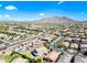 Wide aerial shot of a residential area with houses and mountains in the distance under a clear sky at 2776 E Mews Rd, Gilbert, AZ 85298