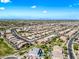 Overhead image of many homes in a neighborhood with sidewalks and desert landscaping and green common areas at 2776 E Mews Rd, Gilbert, AZ 85298