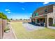 Large backyard with a stone patio, a covered seating area, and a view of the home's exterior at 2776 E Mews Rd, Gilbert, AZ 85298