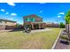 Vast backyard with a well-maintained lawn, covered patio area, and a view of the house at 2776 E Mews Rd, Gilbert, AZ 85298
