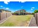 Generous backyard with green grass, a patio area, and a privacy wall around the property at 2776 E Mews Rd, Gilbert, AZ 85298