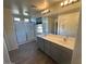 Bright bathroom with double vanity, large mirror, and walk-in shower at 2776 E Mews Rd, Gilbert, AZ 85298