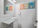 Bright powder room featuring modern vanity, decorative mirror, and quirky wall art at 2776 E Mews Rd, Gilbert, AZ 85298
