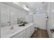 Modern bathroom featuring dual sinks, a large mirror, and a combination shower and bathtub, offering a clean and functional design at 2776 E Mews Rd, Gilbert, AZ 85298