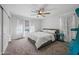 Bright bedroom featuring a ceiling fan, window with white curtains, and minimalist decor for a calming and relaxing space at 2776 E Mews Rd, Gilbert, AZ 85298