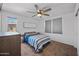 Comfortable bedroom featuring a ceiling fan, large window, and a neutral color scheme, creating a cozy and inviting atmosphere at 2776 E Mews Rd, Gilbert, AZ 85298