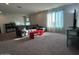 Spacious bonus room with a sectional sofa and plenty of natural light at 2776 E Mews Rd, Gilbert, AZ 85298