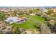 Aerial view of a community park featuring a basketball court, grassy field, and shaded picnic tables at 2776 E Mews Rd, Gilbert, AZ 85298