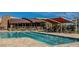 Relaxing community lap pool with lounge chairs and shade at 2776 E Mews Rd, Gilbert, AZ 85298