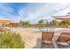 Relaxing poolside lounge chairs near a community pool with shaded umbrellas and splash pad for  at 2776 E Mews Rd, Gilbert, AZ 85298