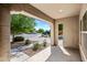 Inviting covered front porch offering a view of the street, landscaped yard, and a glimpse of the community at 2776 E Mews Rd, Gilbert, AZ 85298