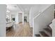 Open hallway leads to the office and dining room, featuring wood-look tile floors and a view of the staircase at 2776 E Mews Rd, Gilbert, AZ 85298
