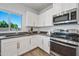 Bright kitchen featuring stainless steel appliances, white cabinets, and a backyard view at 2776 E Mews Rd, Gilbert, AZ 85298