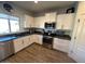 Modern kitchen with white cabinets, dark countertops, and stainless steel appliances at 2776 E Mews Rd, Gilbert, AZ 85298