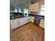 Modern kitchen with white cabinets, dark countertops, and stainless steel appliances at 2776 E Mews Rd, Gilbert, AZ 85298