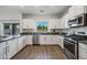 Bright kitchen with stainless steel appliances, light wood floors, and ample counter space at 2776 E Mews Rd, Gilbert, AZ 85298