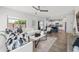 Bright living room with white sofa, ceiling fan, marble coffee table, and access to the kitchen at 2776 E Mews Rd, Gilbert, AZ 85298