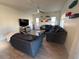 Bright living room with a large sectional sofa and tile flooring at 2776 E Mews Rd, Gilbert, AZ 85298