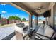 Beautiful outdoor patio with comfortable seating, a ceiling fan, and a view of the lush backyard, ideal for relaxation and entertaining at 2776 E Mews Rd, Gilbert, AZ 85298
