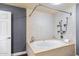 Primary bathroom features a luxurious bathtub, tiled walls, and a corner seat at 2850 E Cortez St, Phoenix, AZ 85028