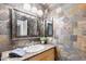Bathroom featuring earth toned tile, overhead vanity lighting, and a mirror at 2850 E Cortez St, Phoenix, AZ 85028