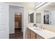 Bathroom features a walk-in closet, wooden cabinets, and a lighted mirror at 2850 E Cortez St, Phoenix, AZ 85028