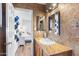 Updated bathroom with granite countertops, wooden cabinets, and tile flooring at 2850 E Cortez St, Phoenix, AZ 85028