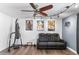 Finished bonus room with wood flooring, ceiling fan, posters, and black leather furniture at 2850 E Cortez St, Phoenix, AZ 85028