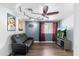 Home theater/bonus room features a flat screen tv, ceiling fan, posters, and black leather furniture at 2850 E Cortez St, Phoenix, AZ 85028