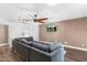 Spacious living room features a large sectional couch, ceiling fan, and hardwood floors at 2850 E Cortez St, Phoenix, AZ 85028