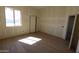 Bright bedroom with tile floors, large window, and open closet ready for finishes at 28551 N 257Th Ave, Wittmann, AZ 85361