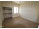 Bright bedroom with a closet and natural light from the window, ready to be customized at 28551 N 257Th Ave, Wittmann, AZ 85361