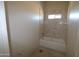 Clean, modern bathroom featuring a bathtub with neutral tiling, providing a serene and relaxing atmosphere at 28583 N 257Th Dr, Wittmann, AZ 85361