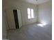 Bright bedroom with tile floor and closet provides a comfortable and adaptable space at 28583 N 257Th Dr, Wittmann, AZ 85361