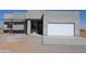 New stucco home featuring a white garage door and covered porch awaiting final construction touches at 28583 N 257Th Dr, Wittmann, AZ 85361
