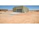 Exterior view of a modern, single-story home with an attached garage in a desert environment at 28583 N 257Th Dr, Wittmann, AZ 85361