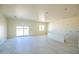 Spacious, bright room with large sliding glass doors and modern tile flooring at 28583 N 257Th Dr, Wittmann, AZ 85361
