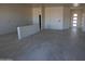 Bright, spacious living space with modern tile flooring and recessed lighting installation in progress at 28583 N 257Th Dr, Wittmann, AZ 85361