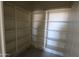 A large walk-in pantry with multiple white shelves for optimal storage and organization at 28583 N 257Th Dr, Wittmann, AZ 85361