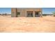 View of the backyard and custom home with ample space and endless possibilities at 28615 N 257Th Dr, Wittmann, AZ 85361