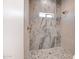 Luxurious bathroom featuring a shower with stylish tile work and a small window at 28615 N 257Th Dr, Wittmann, AZ 85361