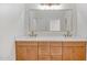 Bright bathroom with double sinks, modern fixtures, and a stylish vanity with ample storage at 28615 N 257Th Dr, Wittmann, AZ 85361